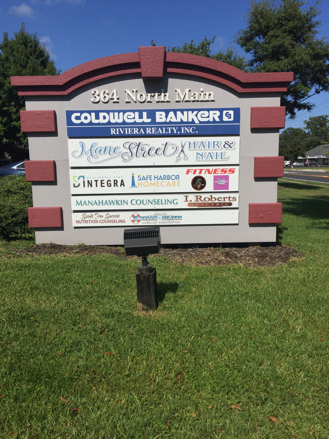 Monument sign for businesses near me featuring multiple tenant sign panels